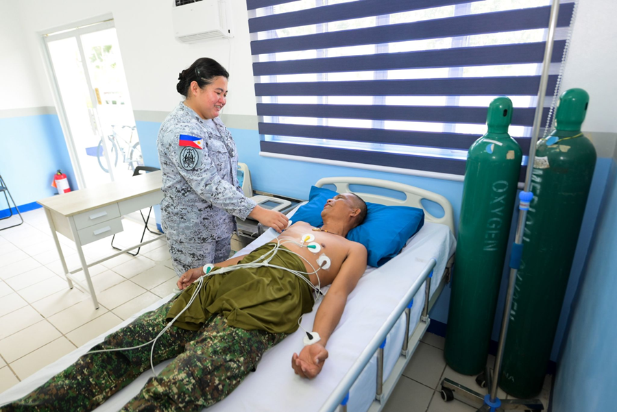 A soldier undergoes an electrocardiogram procedure facilitated by a Philippine Navy health personnel at the Naval Base Rafael Ramos Medical and Dental Dispensary.