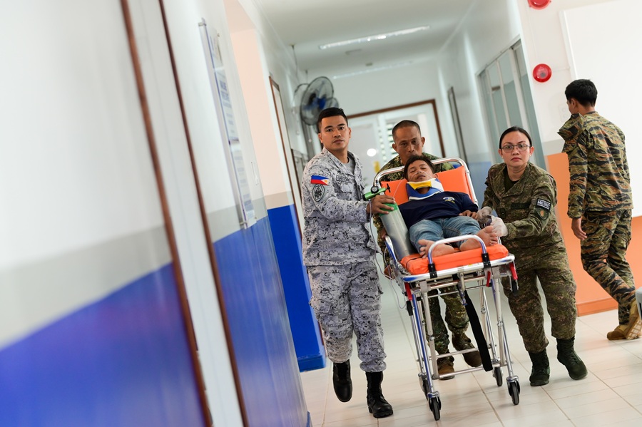 Military health personnel of the Naval Base Rafael Ramos Medical and Dental Dispensary attend to a patient for his medical treatment.
