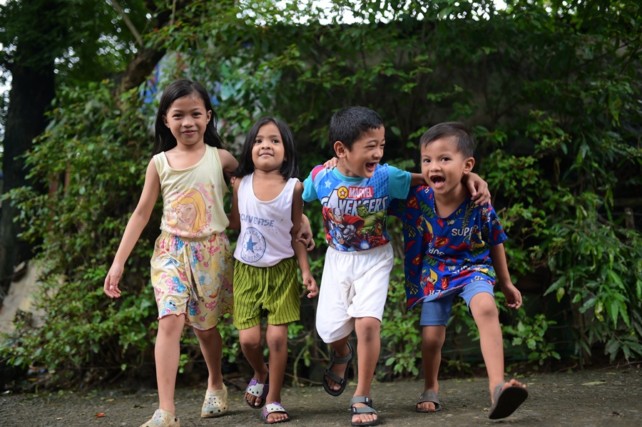 Free from the need for a colostomy bag, Christian (third from left) is able to interact comfortably with his peers, allowing him to experience a joyful childhood.