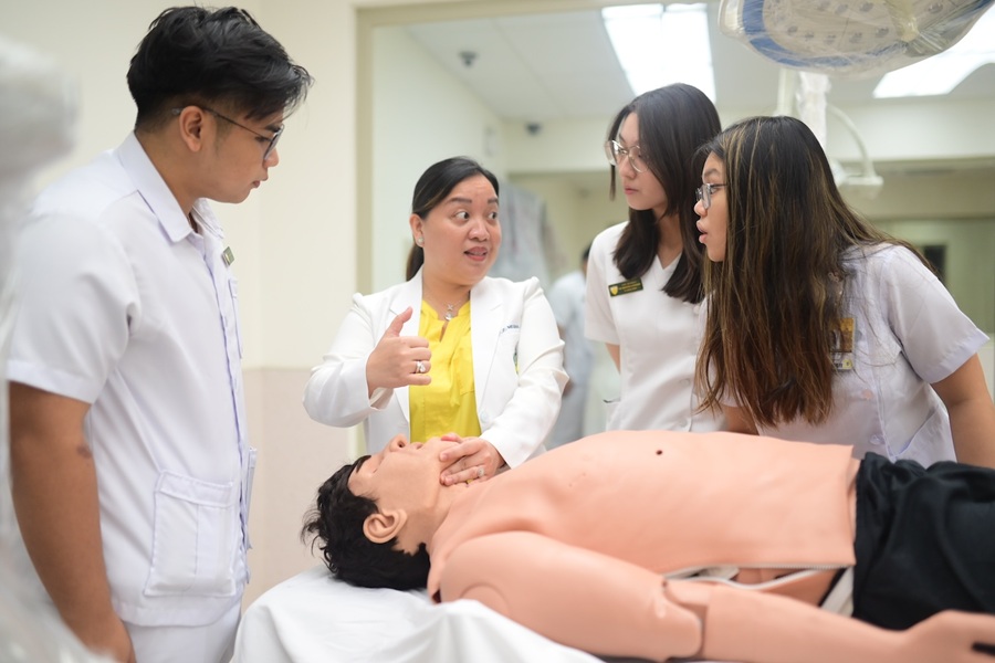 Students of UST-FMS train using high-fidelity mannequins at the Henry Sy Sr. Hall, where advanced simulation and research facilities enhance clinical skills development and prepare future physicians for real-world patient care. 